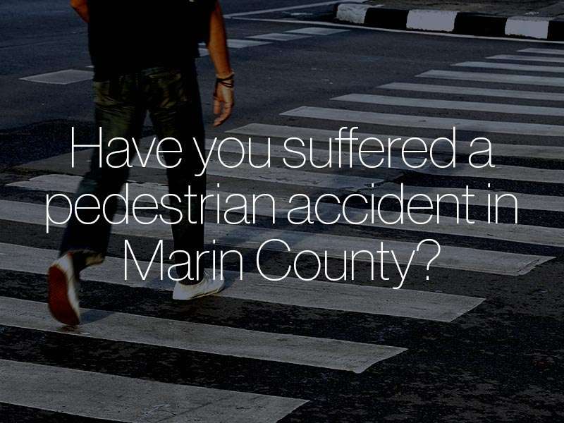 A pedestrian walking across a crosswalk with the text "Have you suffered a pedestrian accident in Marin County?"