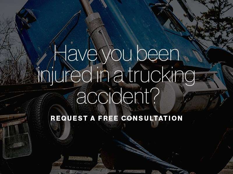 A commercial truck tipped over with the text "Have you been injured in a trucking accident?" superimposed