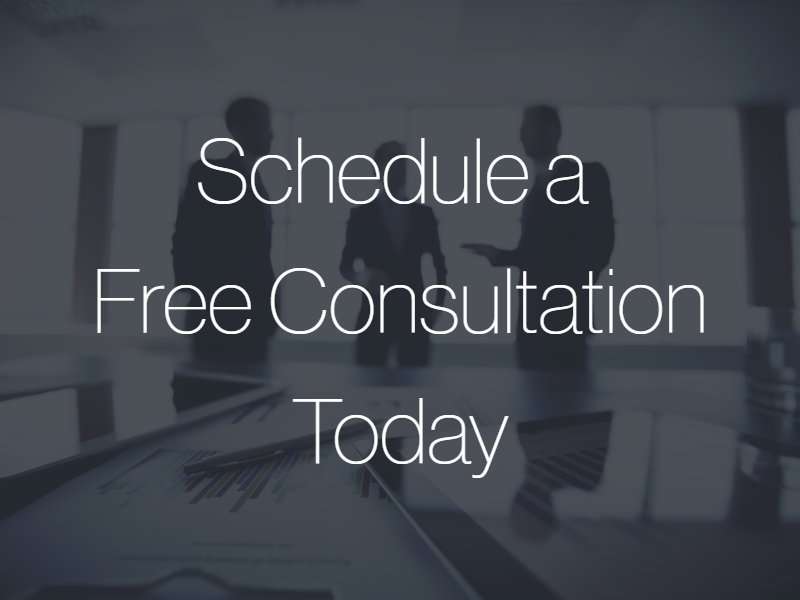 A group of three lawyers talking with the text "Schedule a Free Consultation Today" superimposed